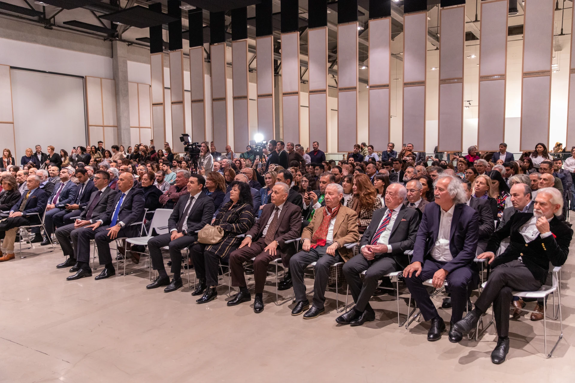 Visitors fill the auditorium for the exhibition's opening programme.