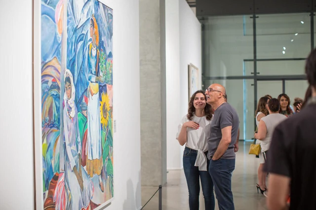 Visitors look at paintings in Labour, Leisure and Dreams at the Museum of Azerbaijani Painting in Baku.
