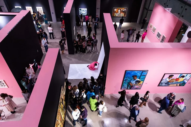 Visitors move through the pink and black partitioned exhibition halls of Pink-Black in Baku.