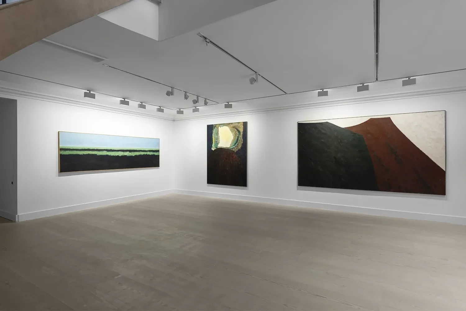 Ground-floor installation of The New Verge, with Farhad Khalilov paintings displayed beneath the staircase at Gazelli Art House.