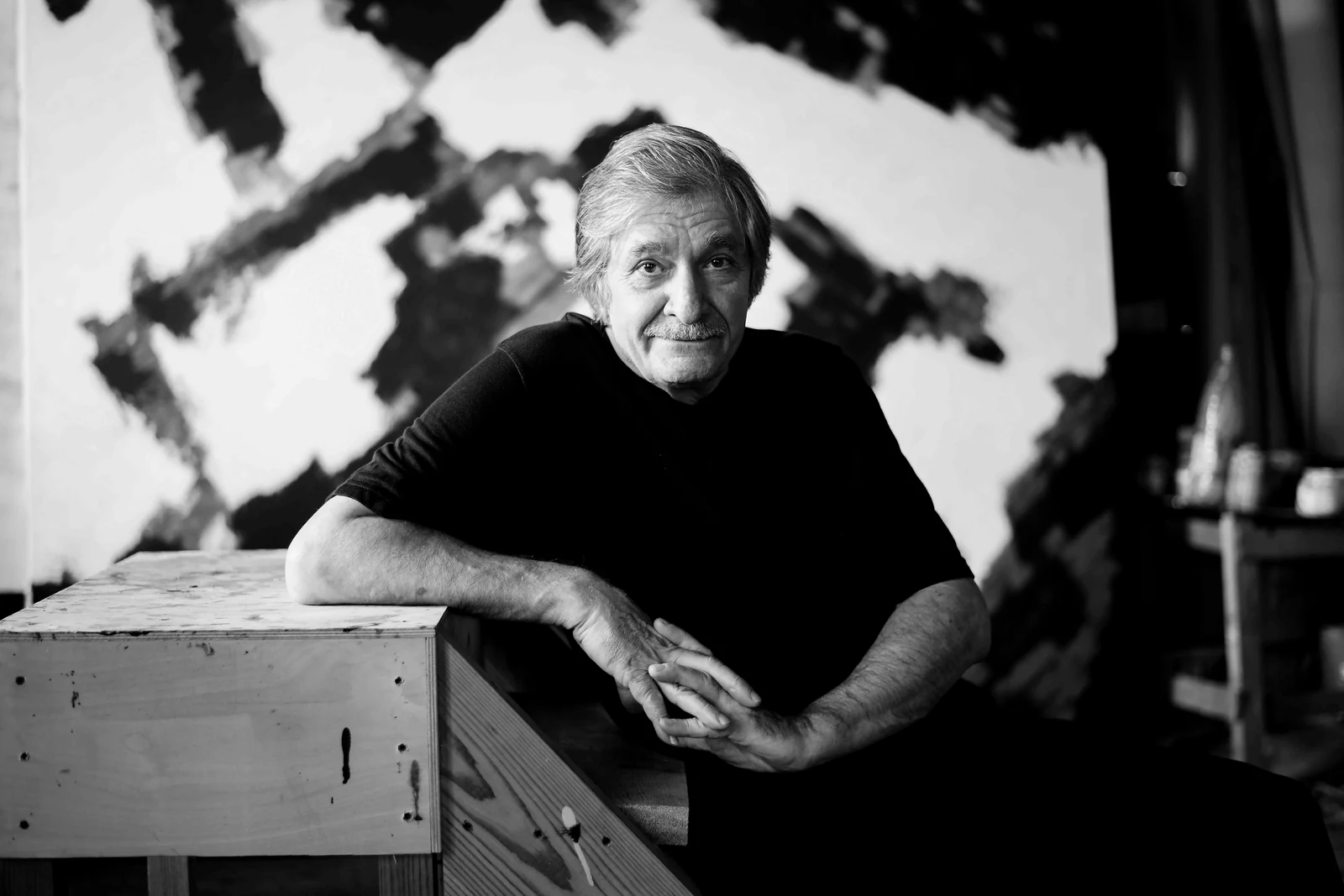 Farhad Khalilov leaning on a studio table. Photograph by Maya Baghirova.