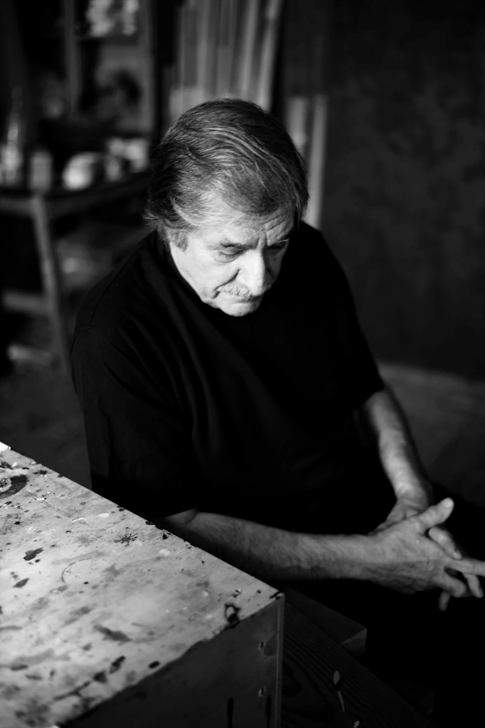 Farhad Khalilov seated beside his work. Photograph by Maya Baghirova.